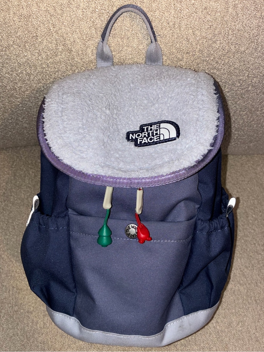 The North Face Kids Navy and Light Gray Backpack with Red & Green Pulls